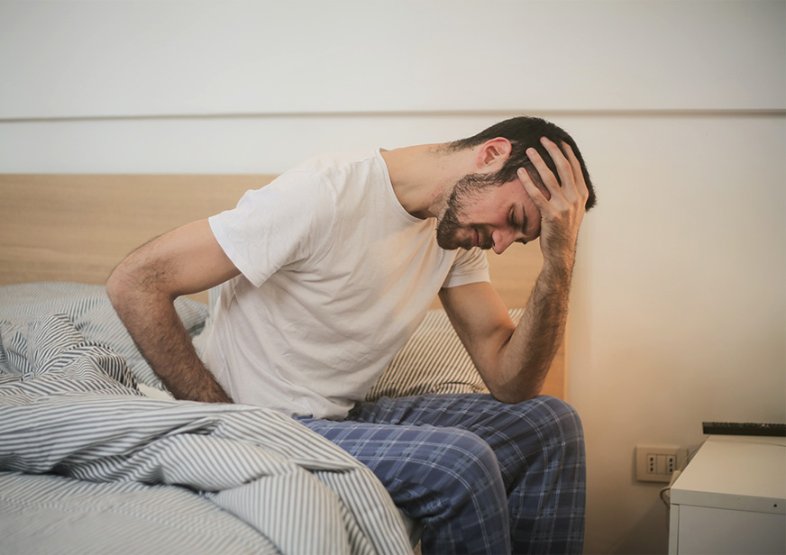 low testosterone - man sitting on bed